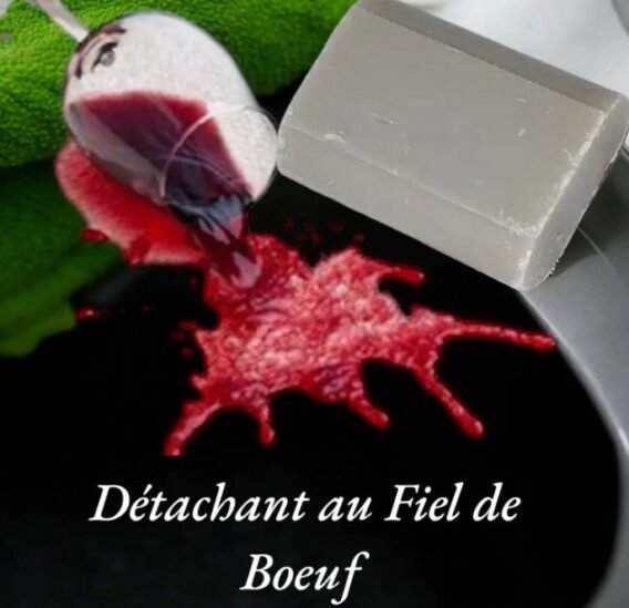 savon détachant à côté d'une tache de vin avec le verre renversé