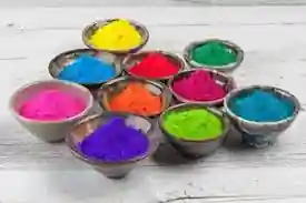 This image showcases several small bowls filled with brightly colored powders. The vibrant colors include yellow, blue, red, green, pink, orange, and purple. These bowls are neatly arranged on a light-colored wooden surface. The array of hues makes the image visually striking and interesting. If you’re into arts and crafts or enjoy working with colors, this setup looks pretty inspiring!