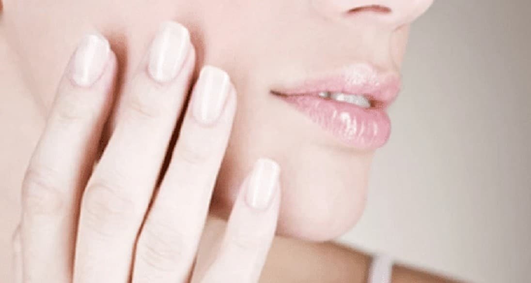 une main touche son visage